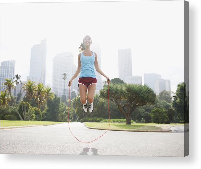 People Acrylic Print featuring the photograph Woman skipping rope in park by Tom Merton