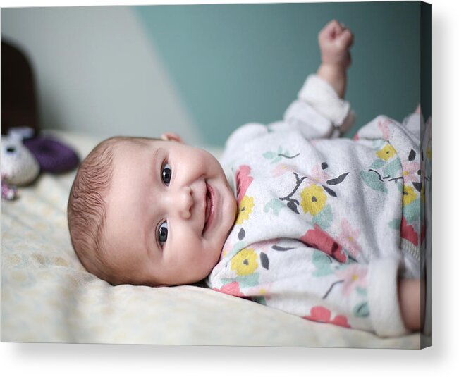 People Acrylic Print featuring the photograph A baby girl smiling on a bed by Catherine Delahaye