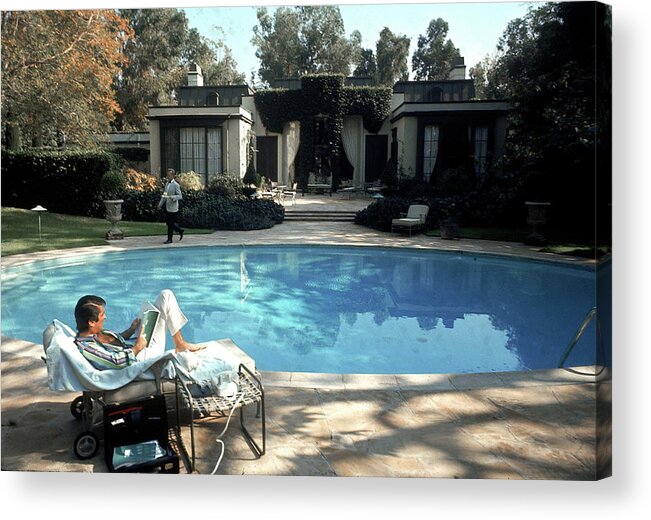 Robert Evans Acrylic Print featuring the photograph Robert Evans Reads Poolside #1 by Alfred Eisenstaedt