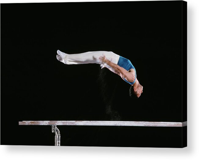 One Man Only Acrylic Print featuring the photograph Male Gymnast Performing On Parallel Bars by David Madison