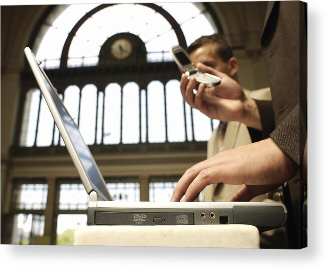 Arch Acrylic Print featuring the photograph Two businessmen using laptop and cell phone, side view. by Teo Lannie