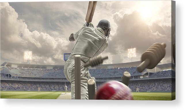 Sports Helmet Acrylic Print featuring the photograph Rear View Of Cricket Ball Hitting Stumps Behind Batsman by Peepo