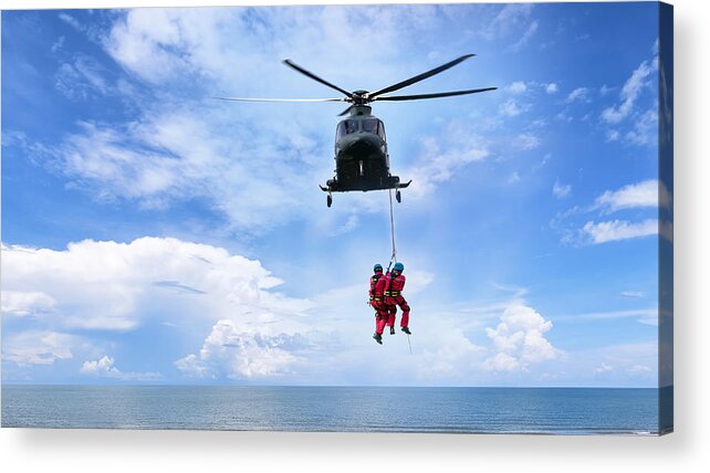 Working Acrylic Print featuring the photograph Background concept for Rescue helicopter in mission sea rescue . by Sarote Pruksachat