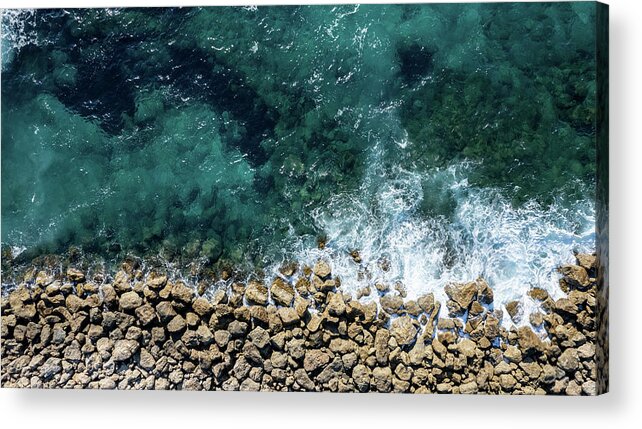 Seascape Acrylic Print featuring the photograph Aerial view from flying drone of crystal blue ocean water and sea wall. by Michalakis Ppalis