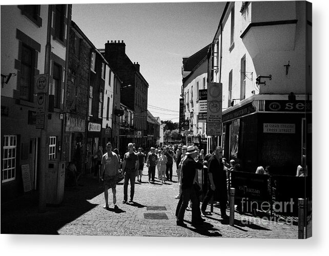 Galway Acrylic Print featuring the photograph pedestrians walking down closed pedestrian area of quay street on sunny sunday afternoon Galway city by Joe Fox