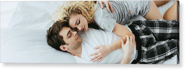 Young Men Acrylic Print featuring the photograph Panoramic Shot Of Happy Couple Hugging While Lying On Bed by LightFieldStudios