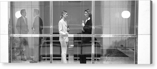 Corporate Business Acrylic Print featuring the photograph Two businesswomen behind large glass window, B&W by Teo Lannie