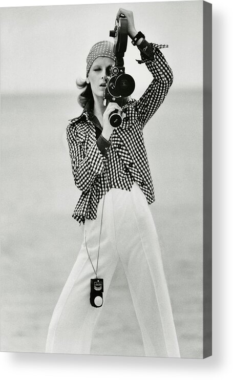 Fashion Acrylic Print featuring the photograph A Model Looking Through A Beaulieu Camera Wearing by Gianni Penati