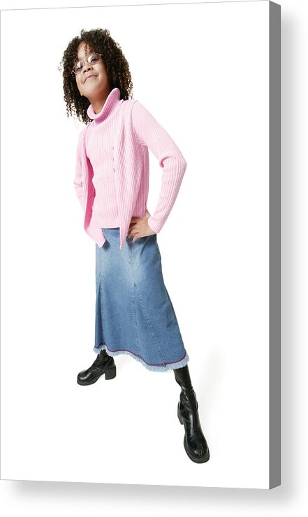 Child Acrylic Print featuring the photograph An African American Girl In Skirt Jeans And A Pink Sweater Puts Her Hands On Her Hips And Smiles by Photodisc