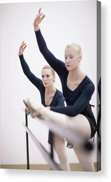 Ballet Dancer Acrylic Print featuring the photograph Female Ballerinas Stretching At The by Zero Creatives