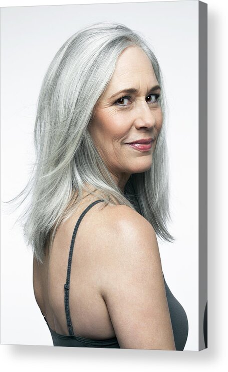 Looking Over Shoulder Acrylic Print featuring the photograph Mature woman with grey hair in a 3/4 position. by Andreas Kuehn