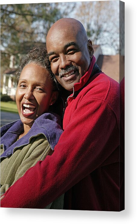 Mature Adult Acrylic Print featuring the photograph Portrait of couple embracing outdoors by Comstock