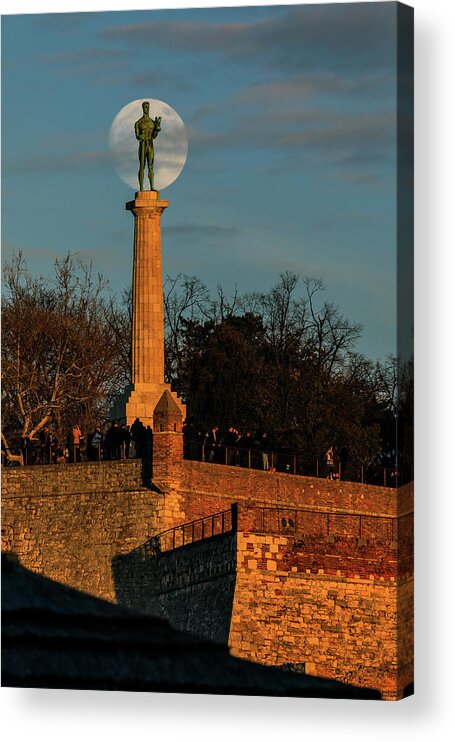 Moon Acrylic Print featuring the photograph The Moon Rising Behind the Victor Statue in Belgrade in the Golden Hour by Dejan Kostic