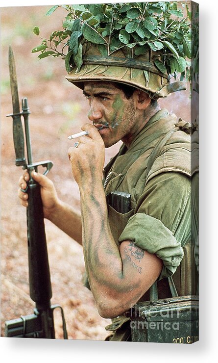 Ho Chi Minh City Acrylic Print featuring the photograph Camouflaged Soldier Smoking Cigarette by Bettmann