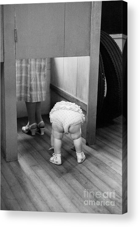 Toddler Acrylic Print featuring the photograph Child Peeking Under Voting Booth by Bettmann