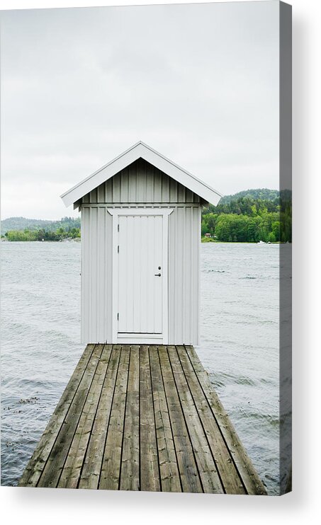 Sweden Acrylic Print featuring the photograph A hut at the end of a wooden lake pier. by Roman Pretot