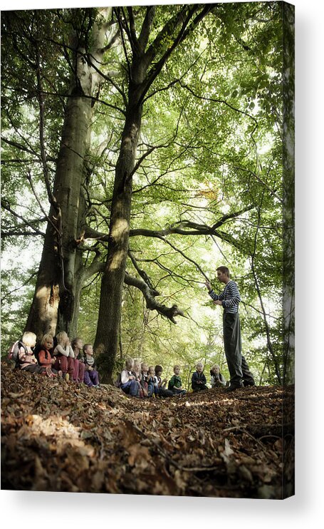 Mid Adult Acrylic Print featuring the photograph Adult storytelling to children in the forest by David Trood