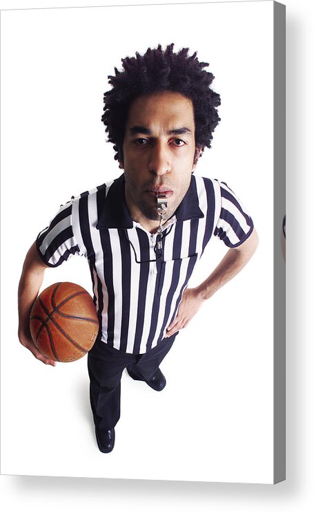 White Background Acrylic Print featuring the photograph An African American Male Referee Blows His Whistle As He Looks Up At The Camera by Photodisc