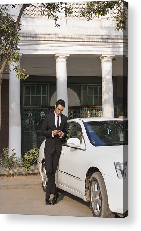 Young Men Acrylic Print featuring the photograph Businessman reading an sms on a mobile phone , INDIA , DELHI by Sudipta Halder