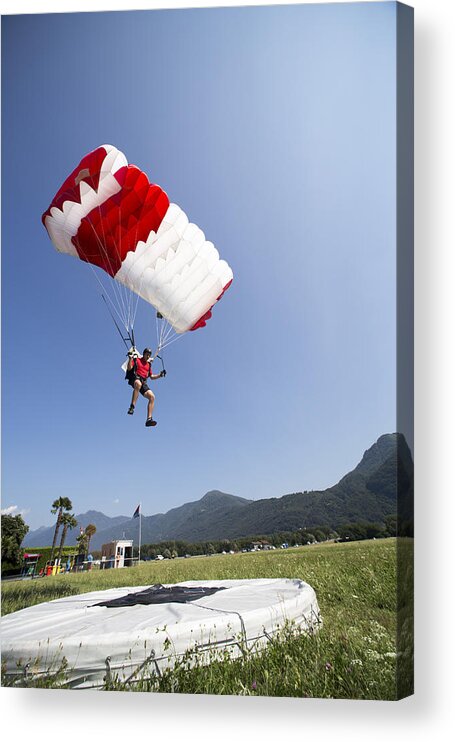 Scenics Acrylic Print featuring the photograph Man under parachute going to land on the target by Oliver Furrer