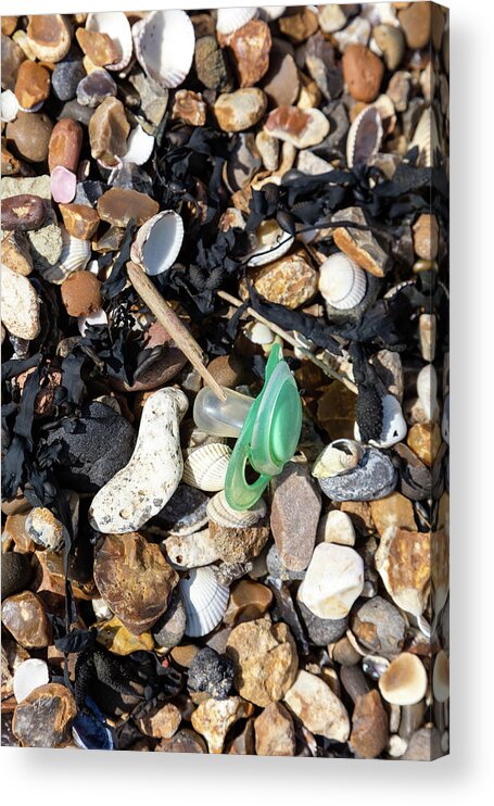 Isle Of Grain Acrylic Print featuring the photograph plastic Baby dummy on pebbles by Richard Donovan