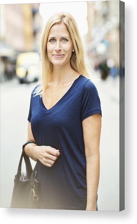 Three Quarter Length Acrylic Print featuring the photograph Portrait of smiling mid adult woman standing on street in city by Maskot
