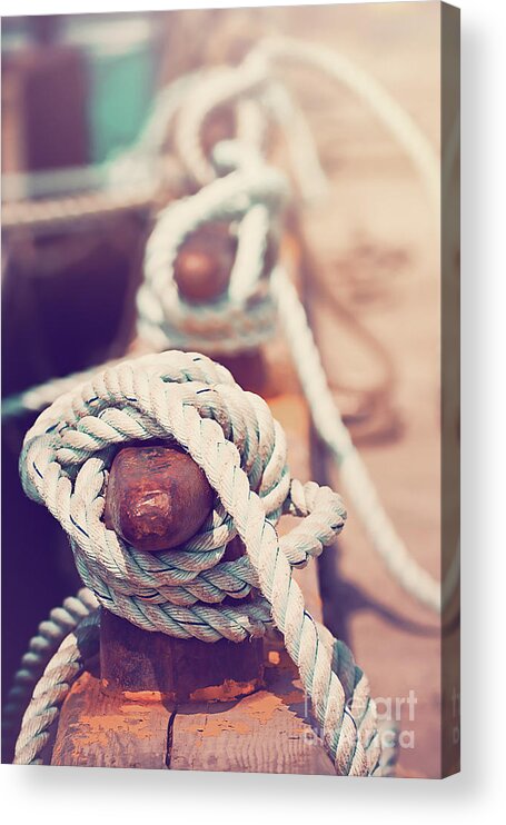 Sea Acrylic Print featuring the photograph Quayside cleats and tied ropes with boats moored in the backgrou by Jane Rix