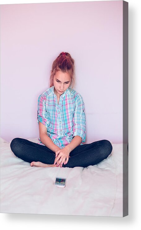 People Acrylic Print featuring the photograph Teenage Girl Looking At Mobile Phone While Sitting On Bed Against Wall by Przemyslaw Klos / EyeEm