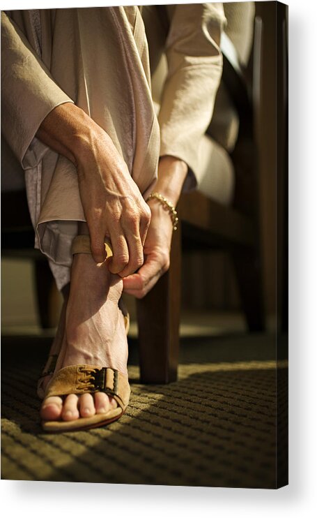 People Acrylic Print featuring the photograph Woman fastening sandal by Thinkstock