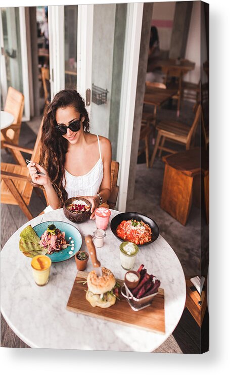 Breakfast Acrylic Print featuring the photograph Young smiling woman having breakfast in stylish street cafe. Smoothie bowl, matcha latte, tacos and burger by Olegbreslavtsev