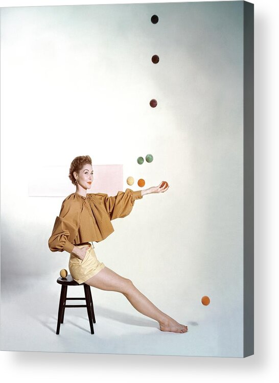 Juggling Acrylic Print featuring the photograph A Model Sitting On A Stool Juggling by John Rawlings