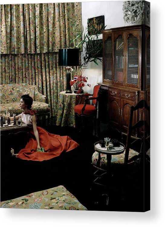 Indoors Acrylic Print featuring the photograph A Young Woman Sitting On The Floor In The Living by Horst P. Horst