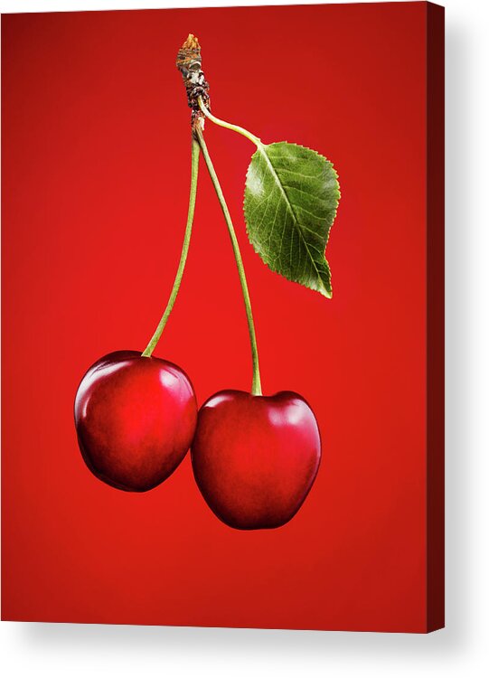 Cherry Acrylic Print featuring the photograph Cherries With Leaf On Red Background by Lauren Burke