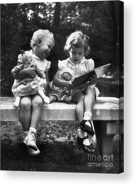 Child Acrylic Print featuring the photograph Girls Holding Dolls Seated On Bench by Bettmann