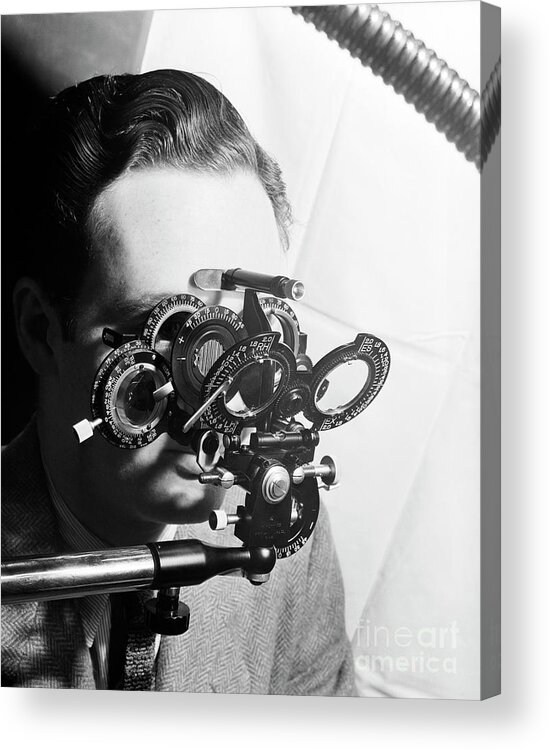 People Acrylic Print featuring the photograph Man Looking Into Phoropter by Bettmann