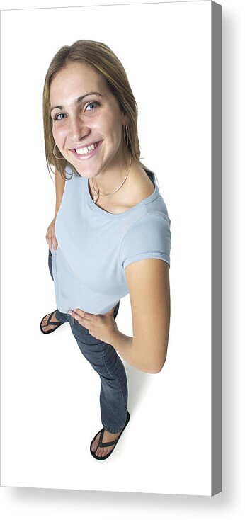 Adolescence Acrylic Print featuring the photograph A Caucasian Female Teen In Jeans And A Blue Shirt Smiles Up At The Camera by Photodisc
