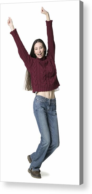 Cool Attitude Acrylic Print featuring the photograph A Young Adult Female In Jeans And A Red Sweater Throws Up Her Arms While Dancing by Photodisc
