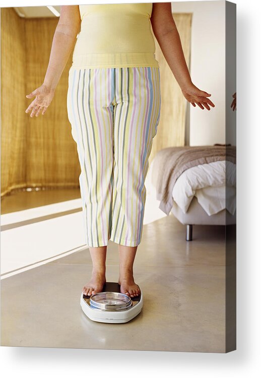 Pedal Pushers Acrylic Print featuring the photograph Low Section View Of A Woman Standing On A Weight Scale by George Doyle