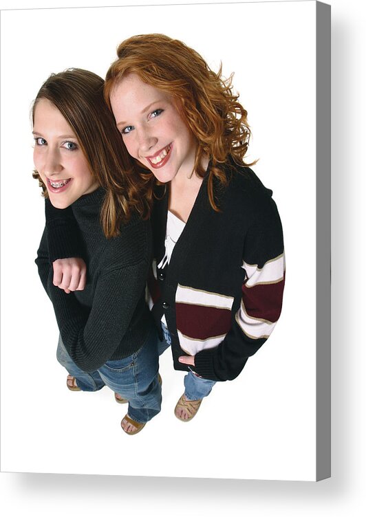 Child Acrylic Print featuring the photograph Two Caucasian Teenager Girls In Jeans And A Black Sweaters Smiles Up Into The Camera by Photodisc
