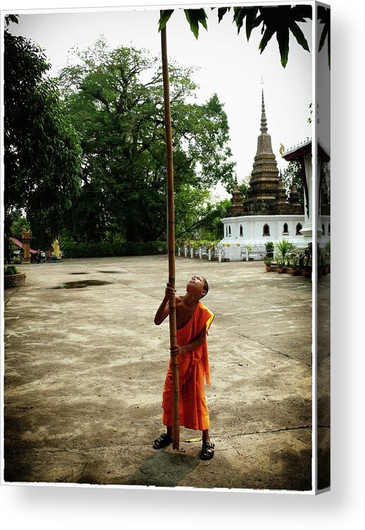 Buddhist Monk Acrylic Print featuring the photograph Young monk with bamboo stick by Robert Bociaga