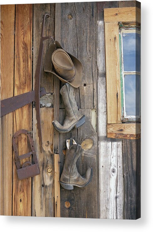 Work Tool Acrylic Print featuring the photograph Cowboy Boots And Hat Hanging On Cabin by Jonathan Kantor Studio