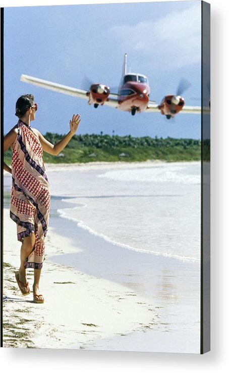Caribbean Model Beach Airplane Bahamas Atlantic Islands Out Islands 1970s Style Outdoors Daytime One Person People Fashion Model Clothing 20-24 Years Young Adult 20s Adult Woman Young Woman Young Adult Woman Brunette Dark Hair Dress Sand Sea Water Transportation Travel Aircraft Passenger Plane Commercial Airplane Aviation Jet Plane Flying Waving Looking Over Shoulder Walking Scarf Dress Lanvin Flip Flops Footwear Sunglasses Eyewear Overcast Overcast Sky Selective Focus #condenastvoguephotograph #condenastvoguephotograph December 1st 1972 Acrylic Print featuring the photograph Model Wearing A Lanvin Dress by Kourken Pakchanian