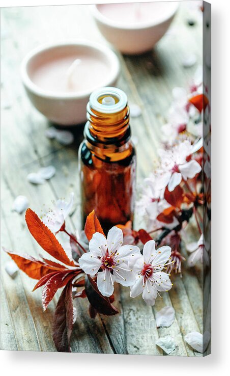 Spa Acrylic Print featuring the photograph Essential massage oil with flower on rustic wooden background. N by Jelena Jovanovic