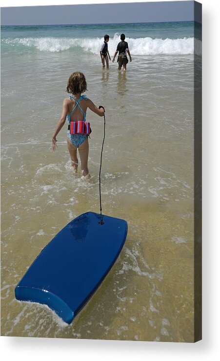 Tranquility Acrylic Print featuring the photograph Girl (5-7) walking into surf, pulling float, rear view by Sami Sarkis