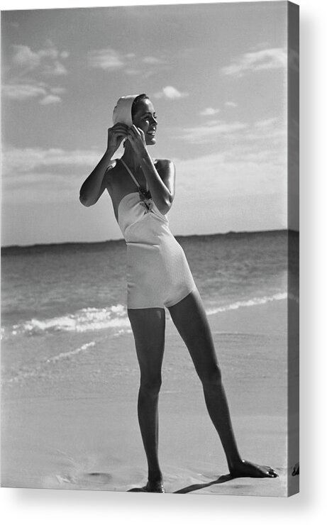 Accessories Acrylic Print featuring the photograph Model on a Beach Fastening Her Bathing Cap by Toni Frissell