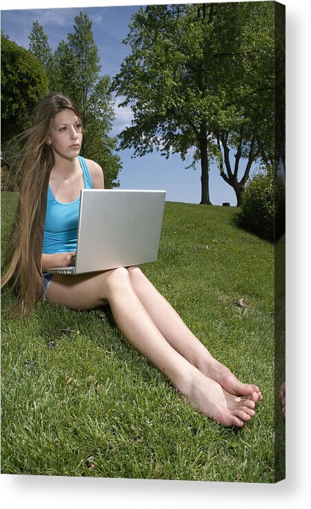 Outdoors Acrylic Print featuring the photograph Teenage girl (16-17) sitting on grass and using laptop by Paul Hanson
