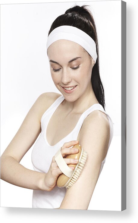 Headband Acrylic Print featuring the photograph Young woman scrubbing her skin with a soft brush by Paper Boat Creative