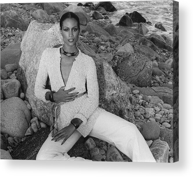Beauty Acrylic Print featuring the photograph Beverly Johnson Sitting On A Rocky Beach by Francesco Scavullo