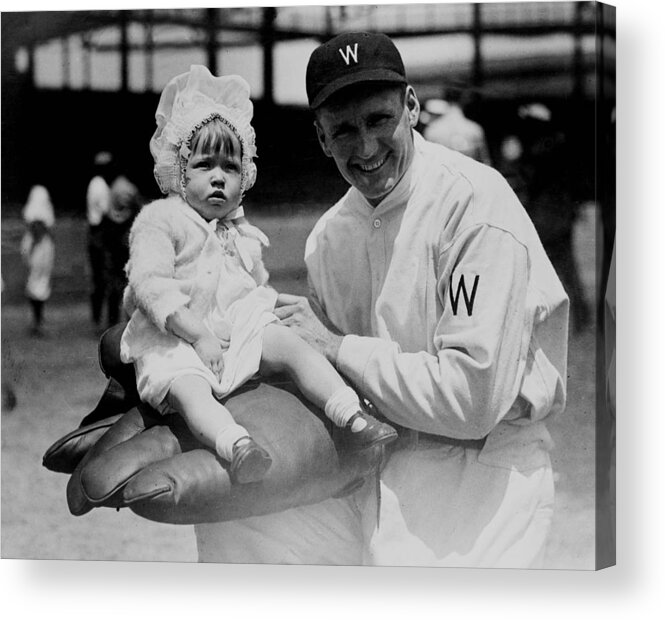 walter Johnson Acrylic Print featuring the photograph Walter Johnson holding a baby - c 1924 by International Images