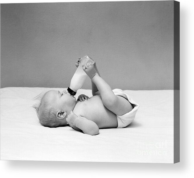 1950s Acrylic Print featuring the photograph Baby Holding Milk Bottle With Feet by H. Armstrong Roberts/ClassicStock